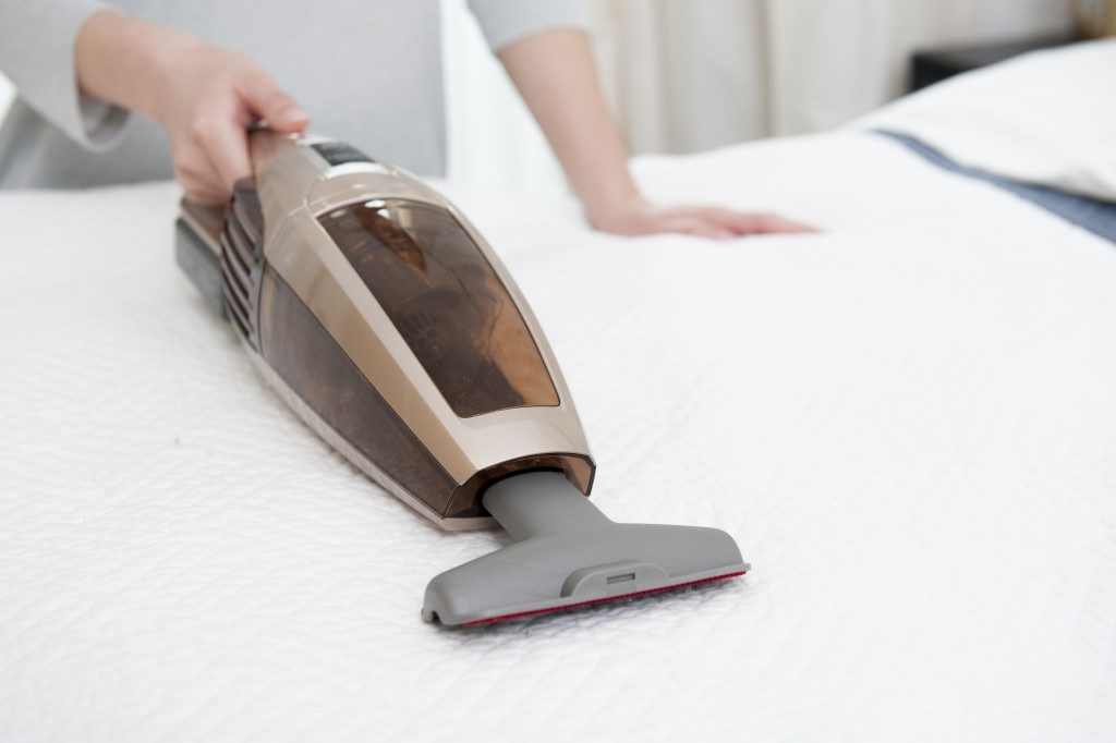 Vacuum cleaning the mattress