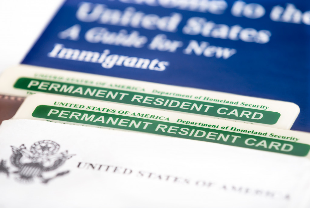United States of America permanent resident cards, green card. Immigration concept. Closeup with shallow depth of field.